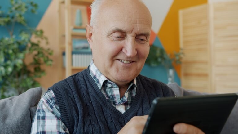Happy senior father using smartphone with grandchild, learning AI